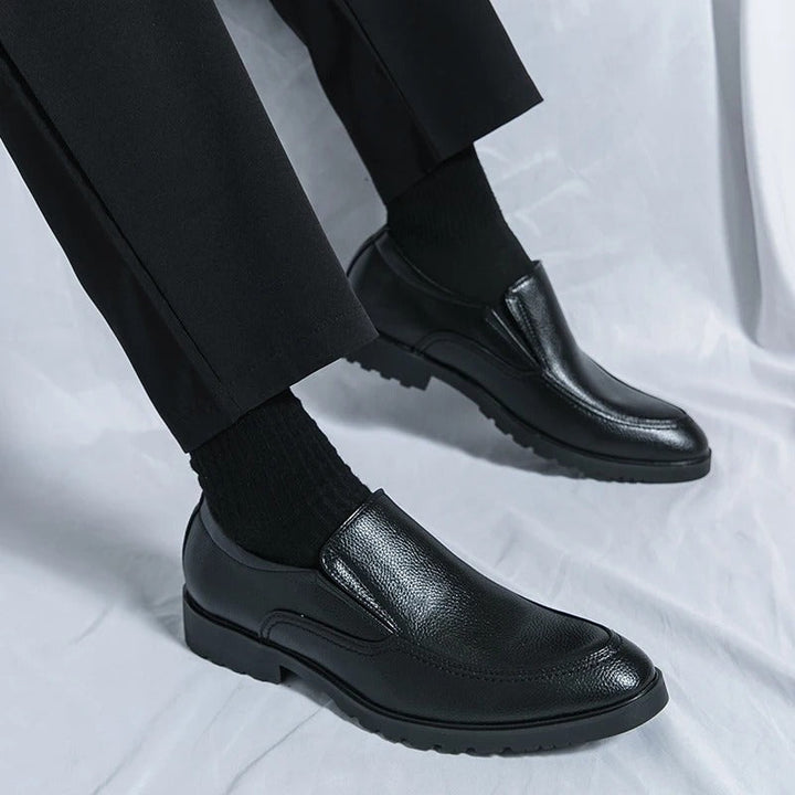 Modern men's slip-on loafers, blending casual comfort with sleek dress shoe design.