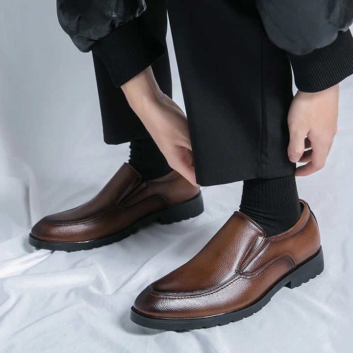 Brown men's slip-on loafers, combining casual appeal with a dressy look. Comfortable fashion.