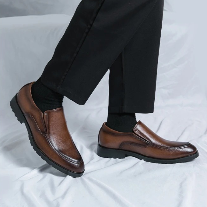 Black men's slip-on loafers, ideal for both casual outfits & formal occasions. Stylish comfort.