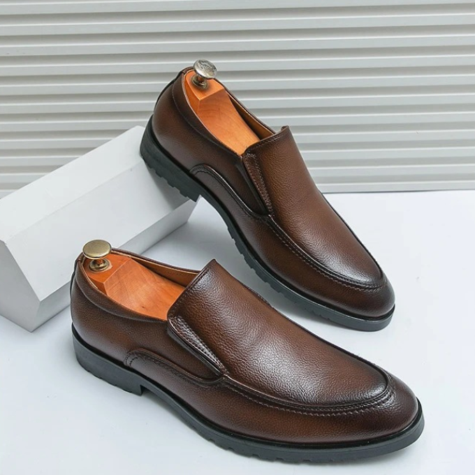 Black men's slip-on loafers, sleek design ideal for office or evening wear. Everyday fashion.