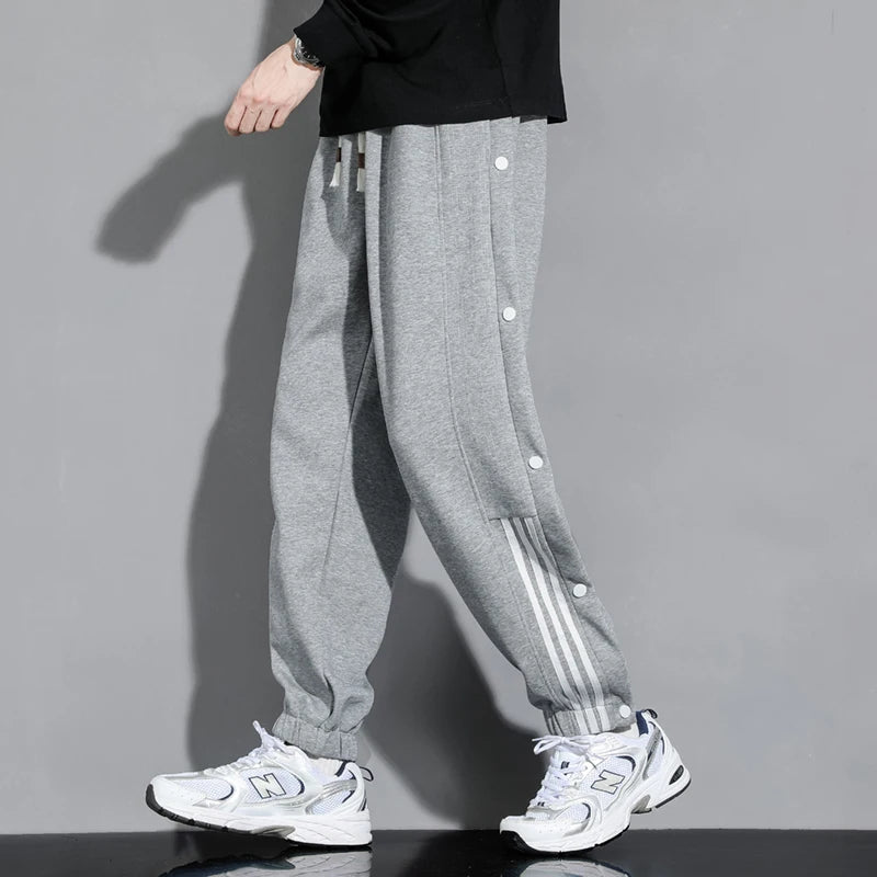 Brown men's snap-track joggers, ideal for casual outings, gym sessions, or relaxed everyday comfort.