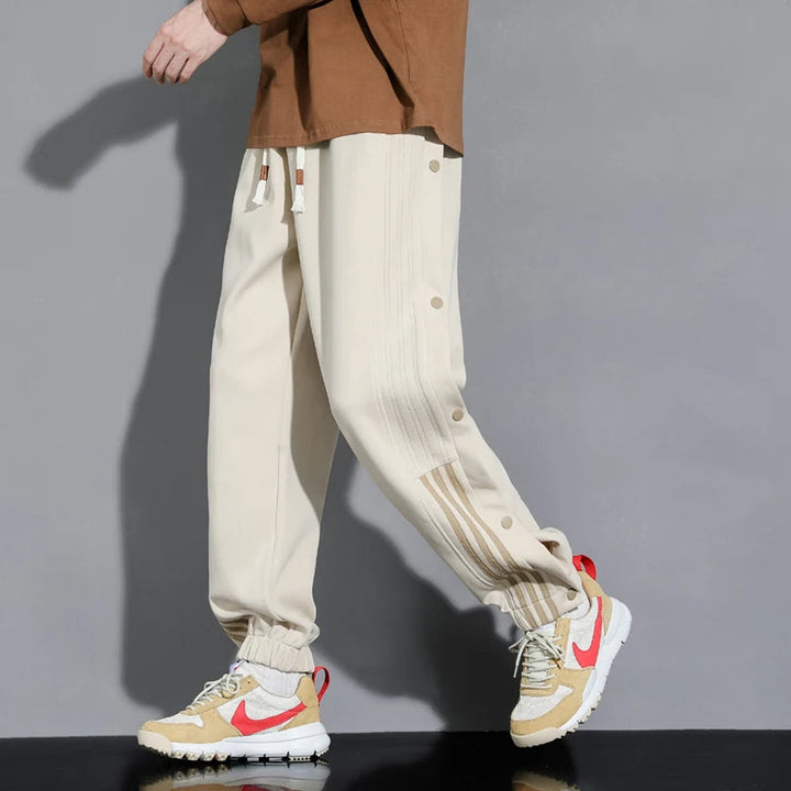 Stylish khaki men's snap-track joggers, offering ultimate comfort & modern design for all-day wear.