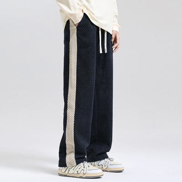 Stylish men's relaxed fit pants in a soft texture, perfect for modern casual wear & everyday comfort. Versatile trousers.