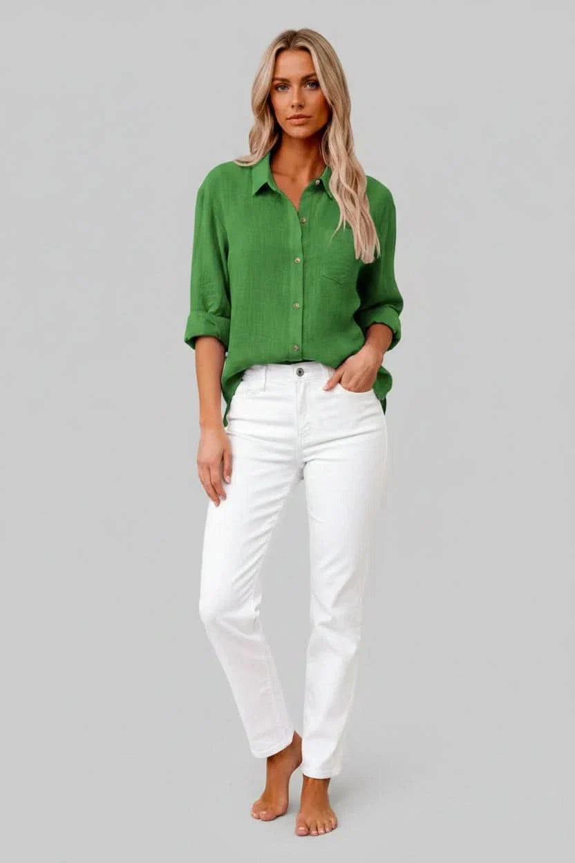 Man modeling a relaxed fit, solid color button-up shirt; ideal lightweight & breathable casual everyday wear.