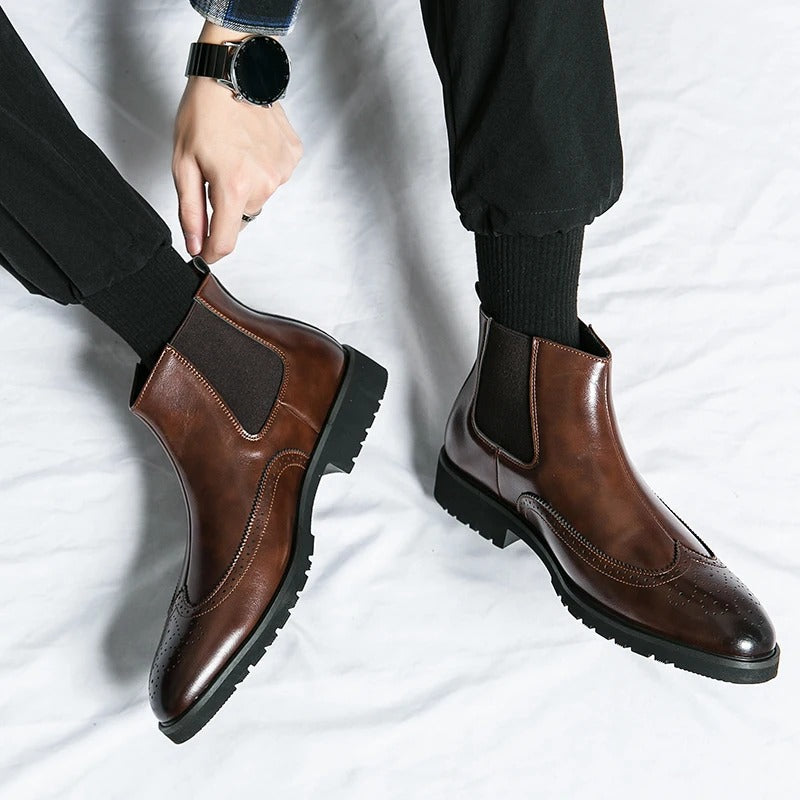 Men's stylish slip-on dress boots, refined Chelsea design with brogue accents.