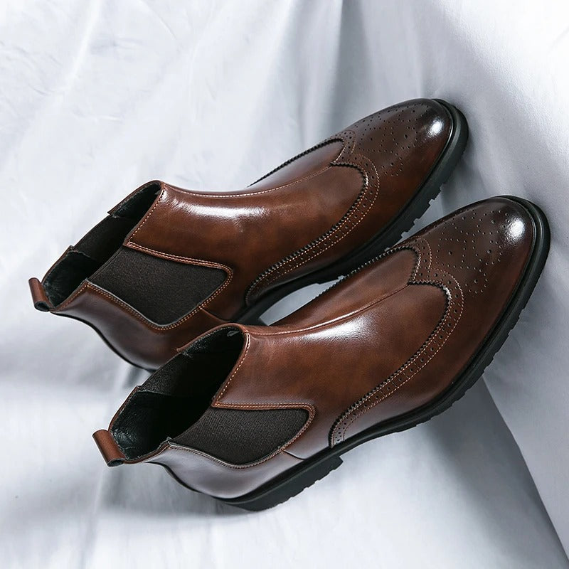 Stylish black leather men's Chelsea boots with comfortable slip-on design.