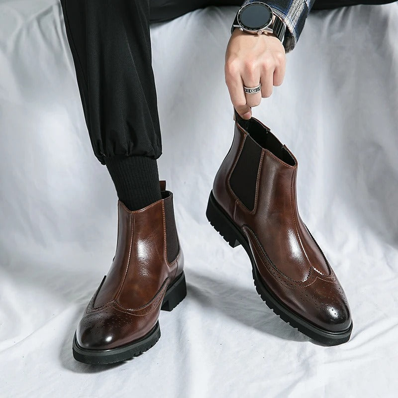 Men's formal slip-on dress boots, sleek Chelsea design with brogue detail.