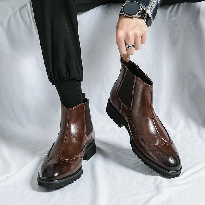 Men's formal slip-on dress boots, sleek Chelsea design with brogue detail.