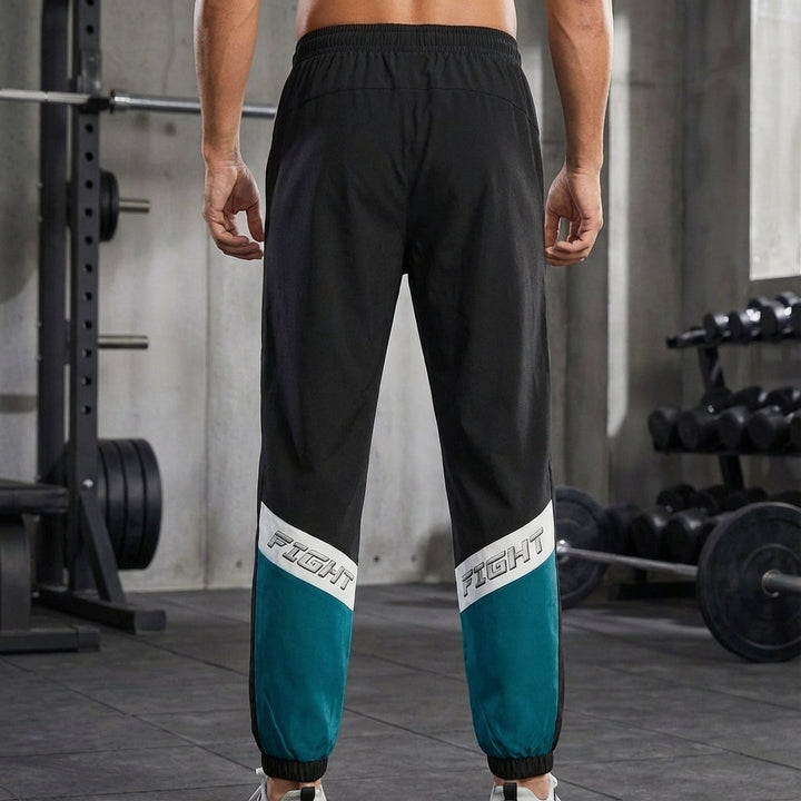 Men's sporty grey jogging trousers for activewear and casual comfort, made of cotton blend.