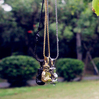 Detailed view of a unique boxing glove pendant on a men's stainless steel necklace, statement gift for him.