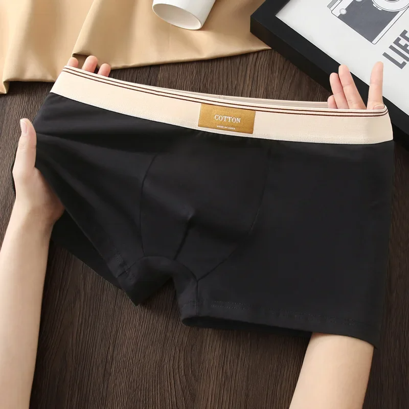 Stylish black men's boxer briefs, featuring a no-roll waistband for a secure, stay-tucked fit.