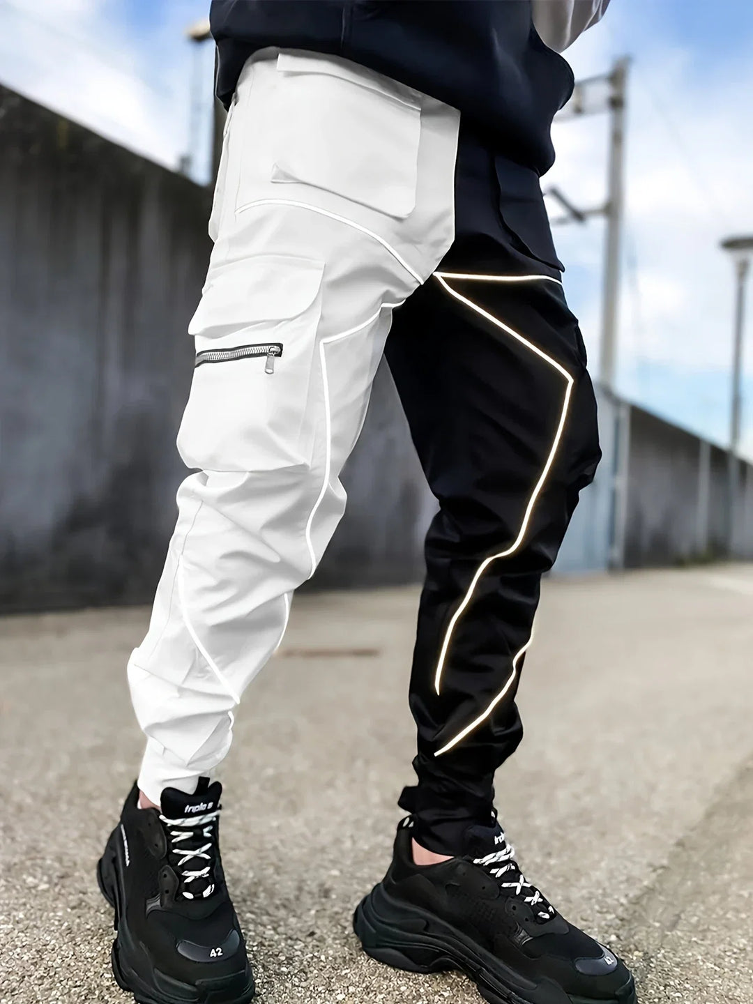 Man modeling men's Stealth reflective cargo jogger pants, showcasing urban street style.