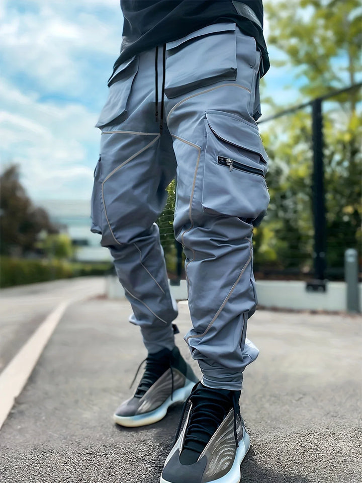 Side profile of men's lightweight reflective cargo jogger pants, showcasing the stealth design.