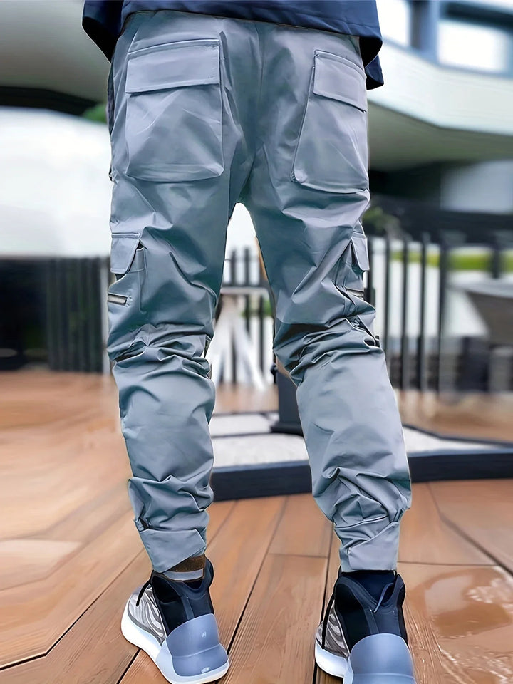 Close-up of reflective detail on men's Stealth cargo jogger pants, enhancing visibility.