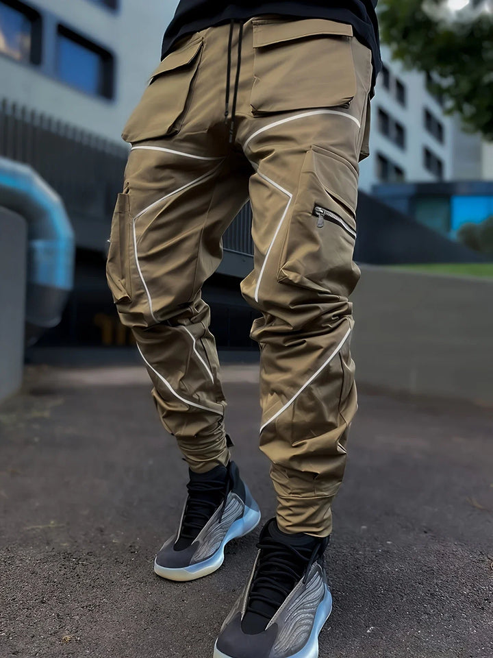 Full-length shot of men's casual reflective cargo jogger pants in a modern street style fit.