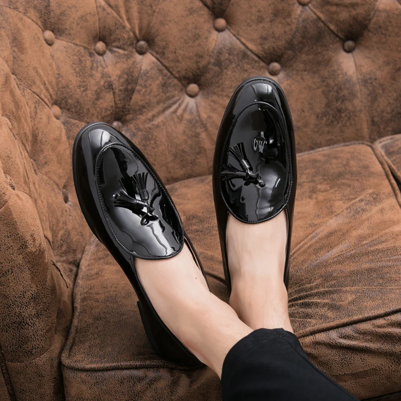Polished black tassel loafers for men, offering comfort and timeless dress shoe style.