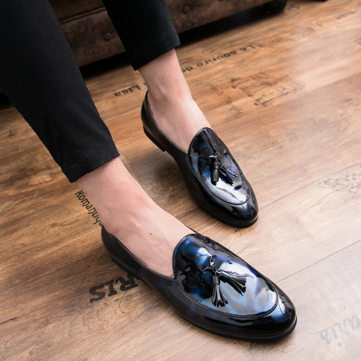 Polished black men's loafers, classic tassel design, luxurious and comfortable.