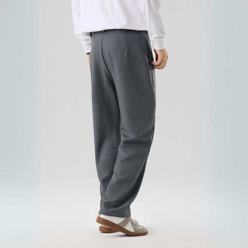 Man wearing comfortable men's Sterling pleated trousers, showcasing relaxed fit & modern style.