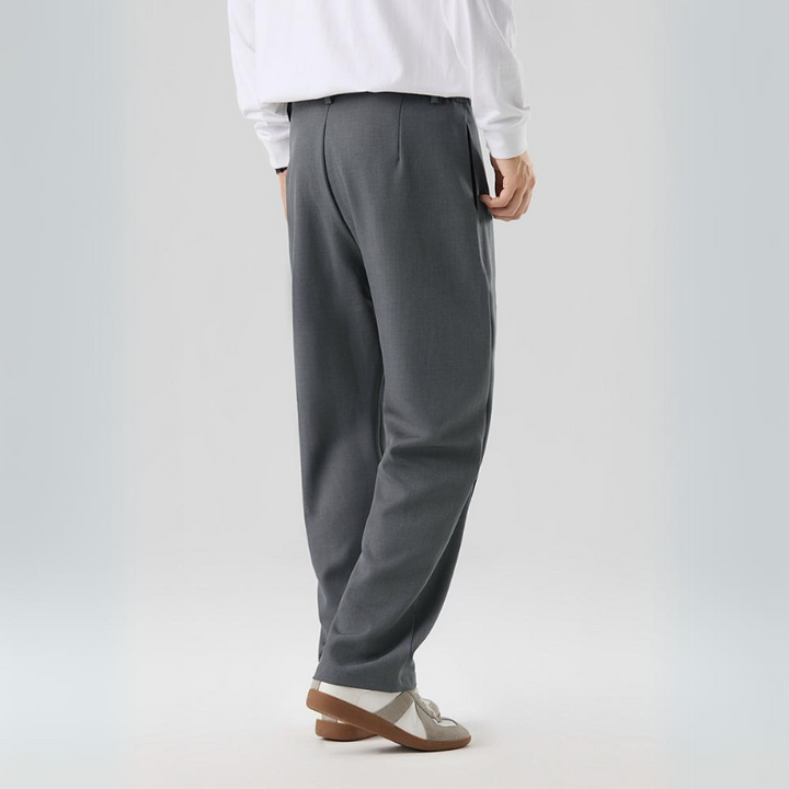 Man wearing comfortable men's Sterling pleated trousers, showcasing relaxed fit & modern style.