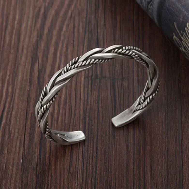 Handcrafted men's braided sterling silver open cuff bracelet, featuring an intricate design and oxidized finish.