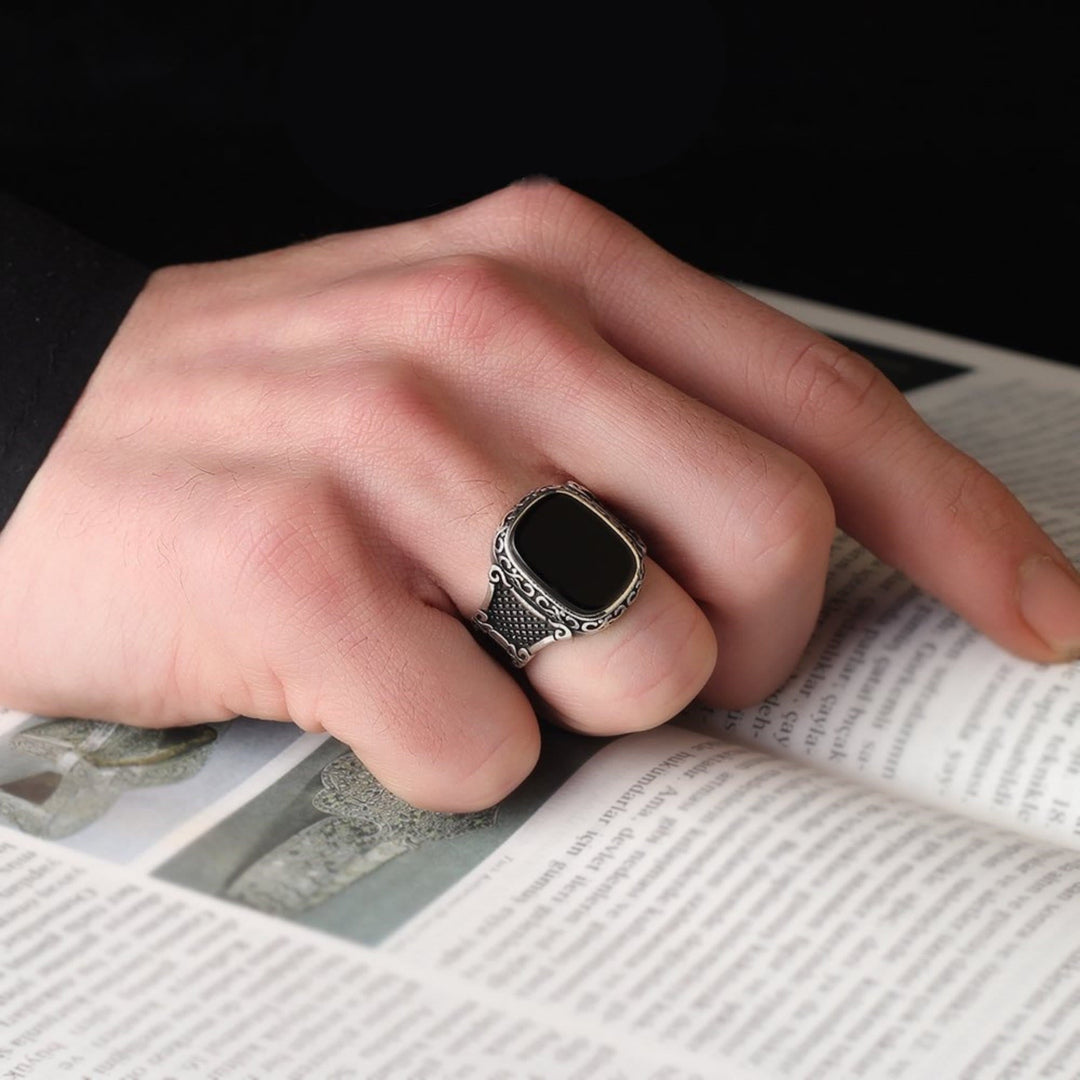 Men's sterling silver ring with a sleek black onyx gemstone, perfect for a masculine look.