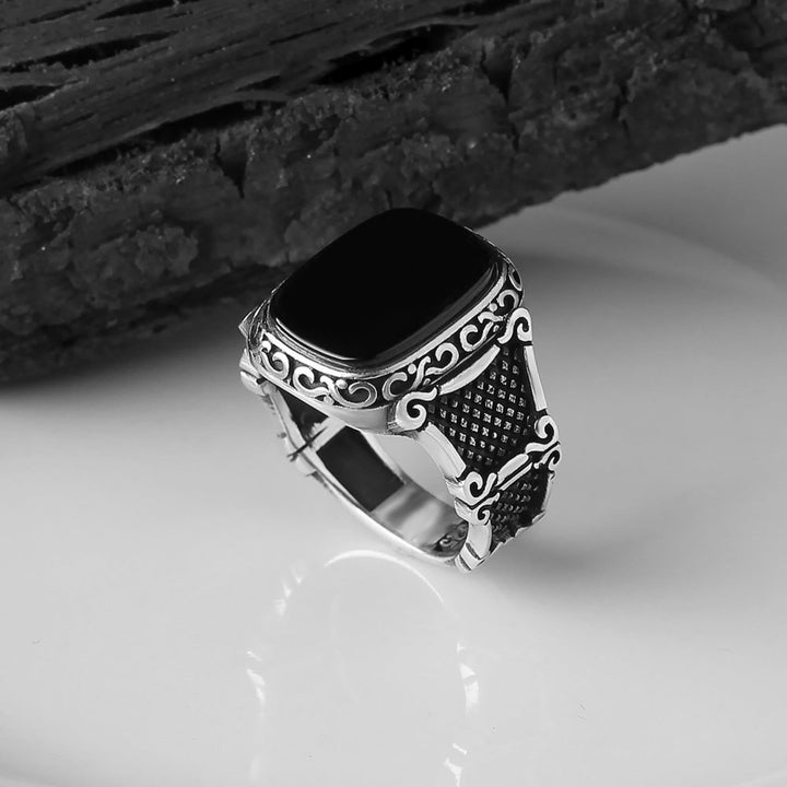 Elegant men's sterling silver statement ring featuring a bold black onyx stone.