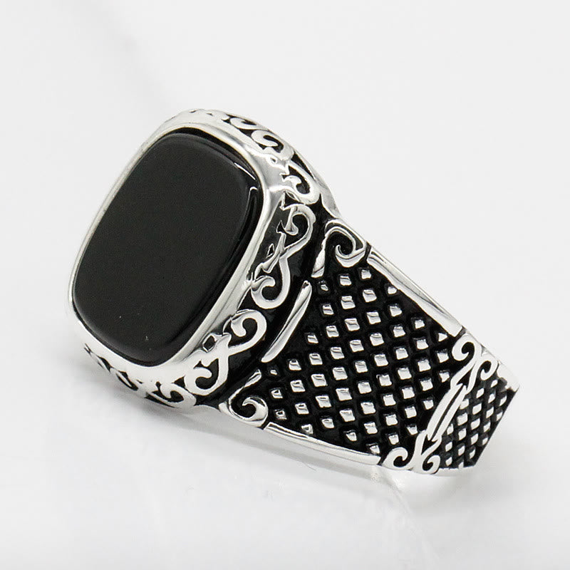 Stylish black onyx men's ring made from sterling silver, worn elegantly on a finger.