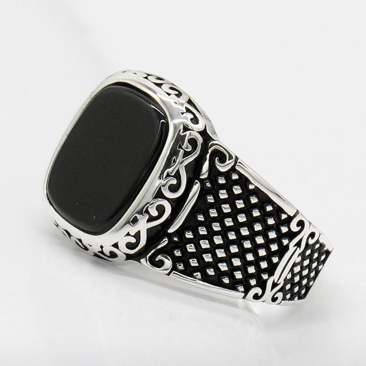Stylish black onyx men's ring made from sterling silver, worn elegantly on a finger.
