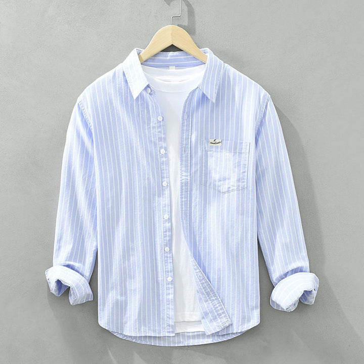 Versatile men's striped button-up shirt, modern fit, great for casual spring/summer fashion.