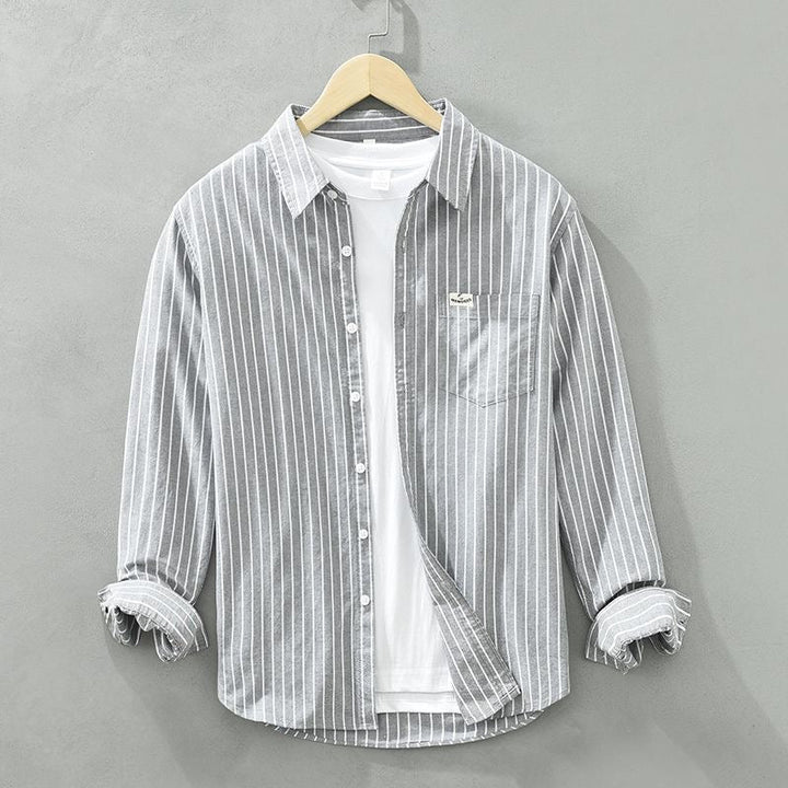 Close-up of men's modern fit casual shirt, showcasing stylish stripes & quality fabric texture.
