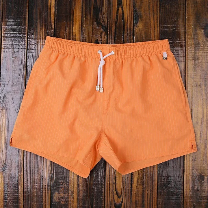 Comfortable men's striped beach shorts with an elastic waist, versatile summer apparel.