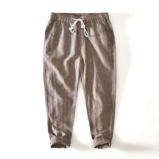 Full-length view of men's casual striped pants, relaxed fit with drawstring, offering comfort and style.
