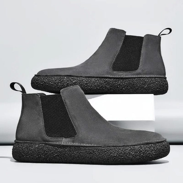 Sleek men's Chelsea boots featuring elastic side panels & cushioned orthopedic footbed.