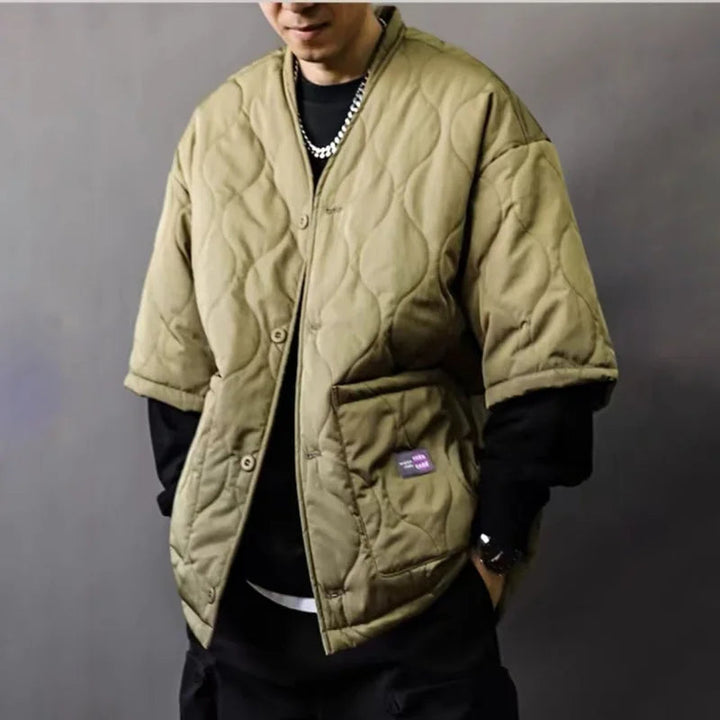 Modern men's quilted bomber jacket with ribbed cuffs & collar, stylish streetwear for casual fall outfits.