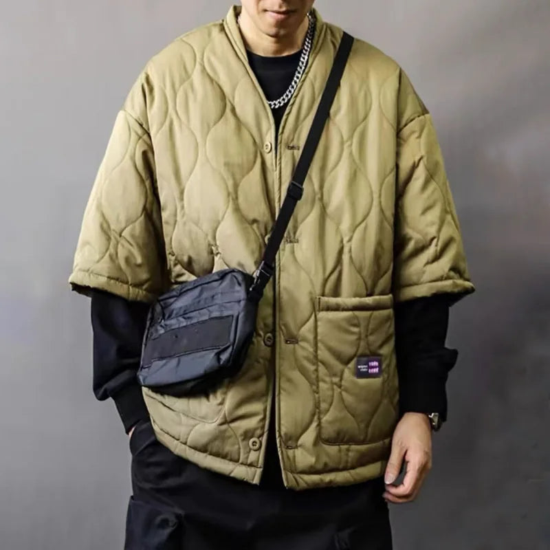Durable men's quilted bomber jacket featuring secure utility pockets, offering comfort & warmth for modern urban style.