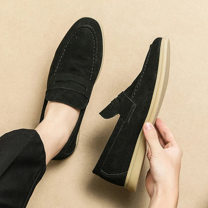Stylish black men's slip-on loafers, offering effortless elegance & comfort for modern formal/casual fashion.
