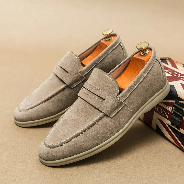 Close-up of men's elegant black slip-on loafers, showcasing sophisticated design & comfortable fit. Men's fashion.