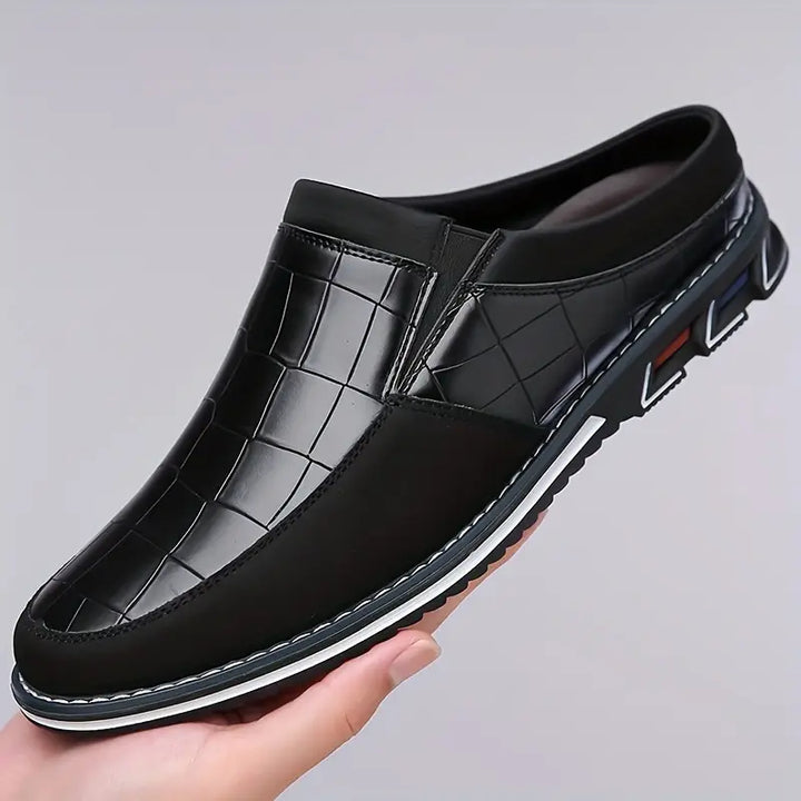 Men's stylish black slip-on mules for all-day comfort and modern everyday wear.