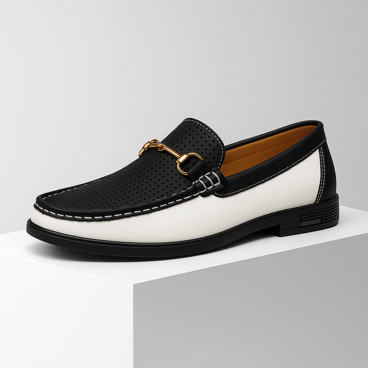 Close-up of men's bit loafer showing intricate stitching & polished metal hardware; luxurious dress shoes.