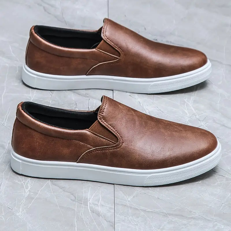 Men's stylish brown slip-on loafers. Versatile, comfortable footwear for casual or formal everyday wear.