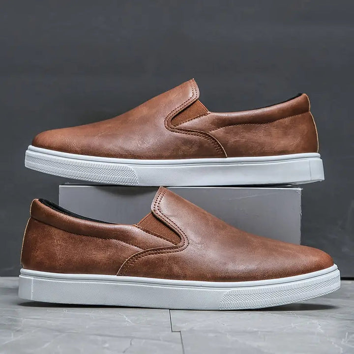 Side view of comfortable men's brown slip-on loafers. Stylish everyday footwear with sleek design.