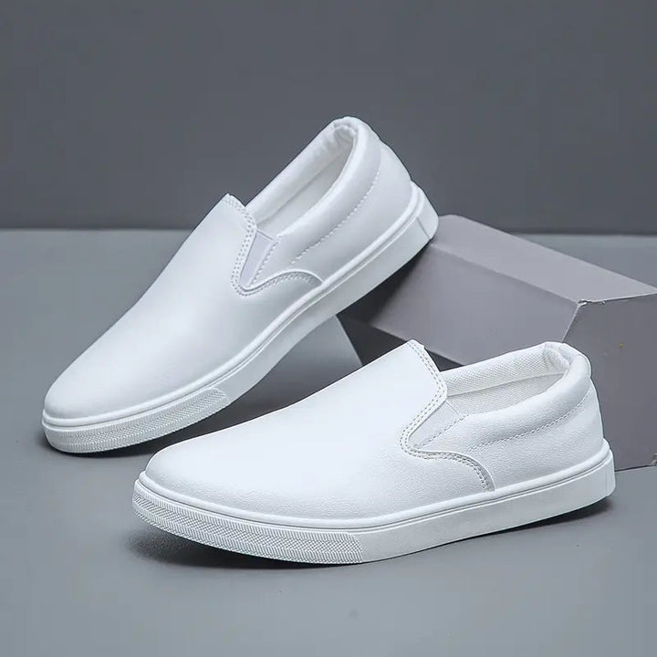 Top-down view of men's black slip-on loafers. Comfortable, sleek, and versatile everyday footwear for men.