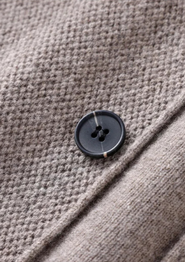 Stylish men's fashion button-up cardigan sweater, versatile for layering and smart casual outfits.