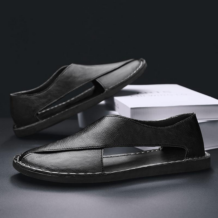 Fashionable men's cross-strap sandals, elevating casual summer and beach outfits.