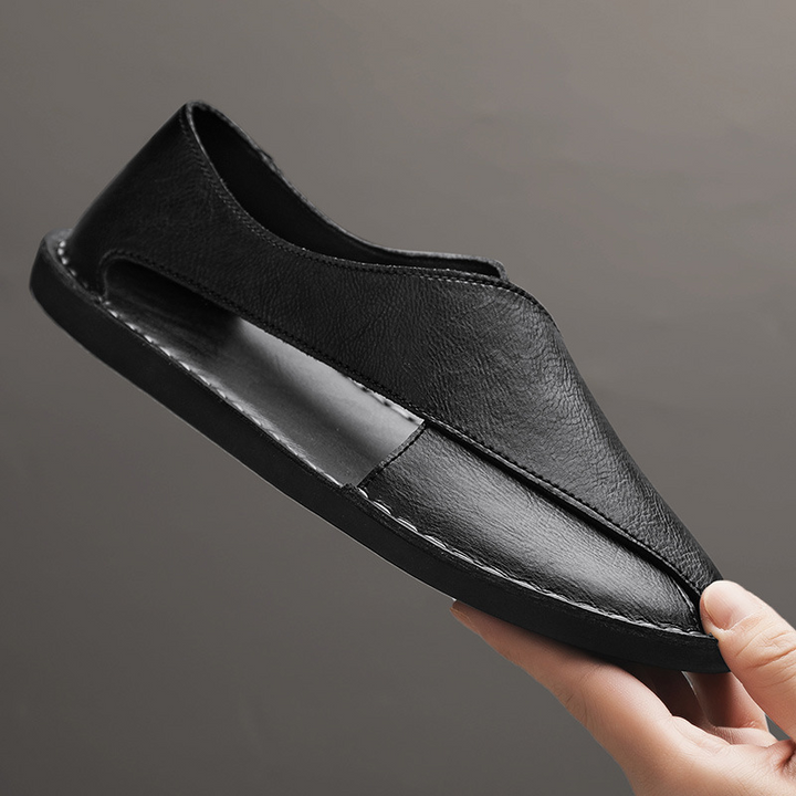 Textured detail on men's comfort cross-strap sandals, enhancing grip and style.