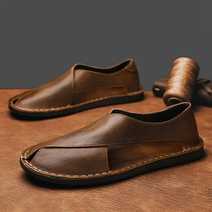 Close-up of stylish men's cross-strap sandals, highlighting the comfortable design.