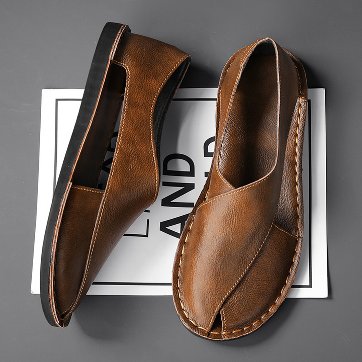 Top-down view of men's fashion cross-strap sandals with open-toe design.