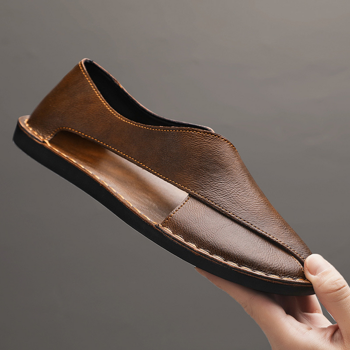 Men's comfort cross-strap sandals worn in a relaxed setting, great for summer.