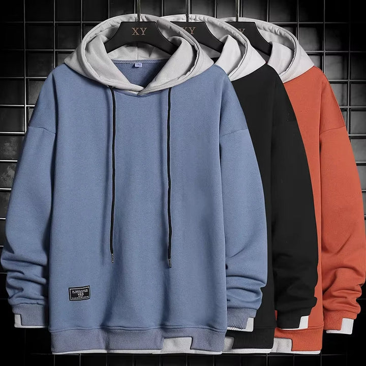 Stylish men's dual-tone hoodie with a unique layered hem. This comfortable casual pullover is great for a modern look.