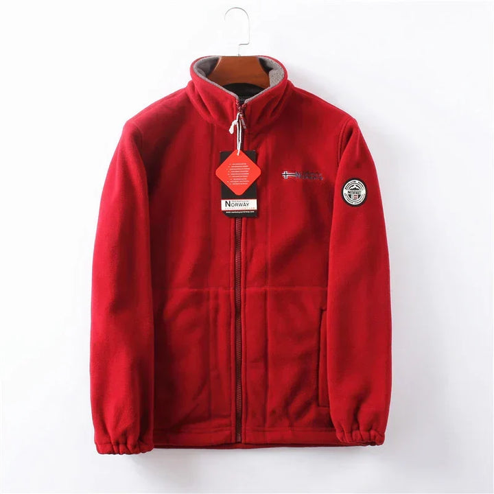 Man wearing a warm gray full-zip winter jacket, perfect for outdoor activities & casual wear.